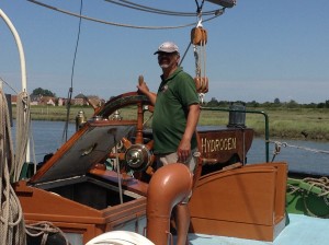 man driving hydrogen boat in essex at ships wheel